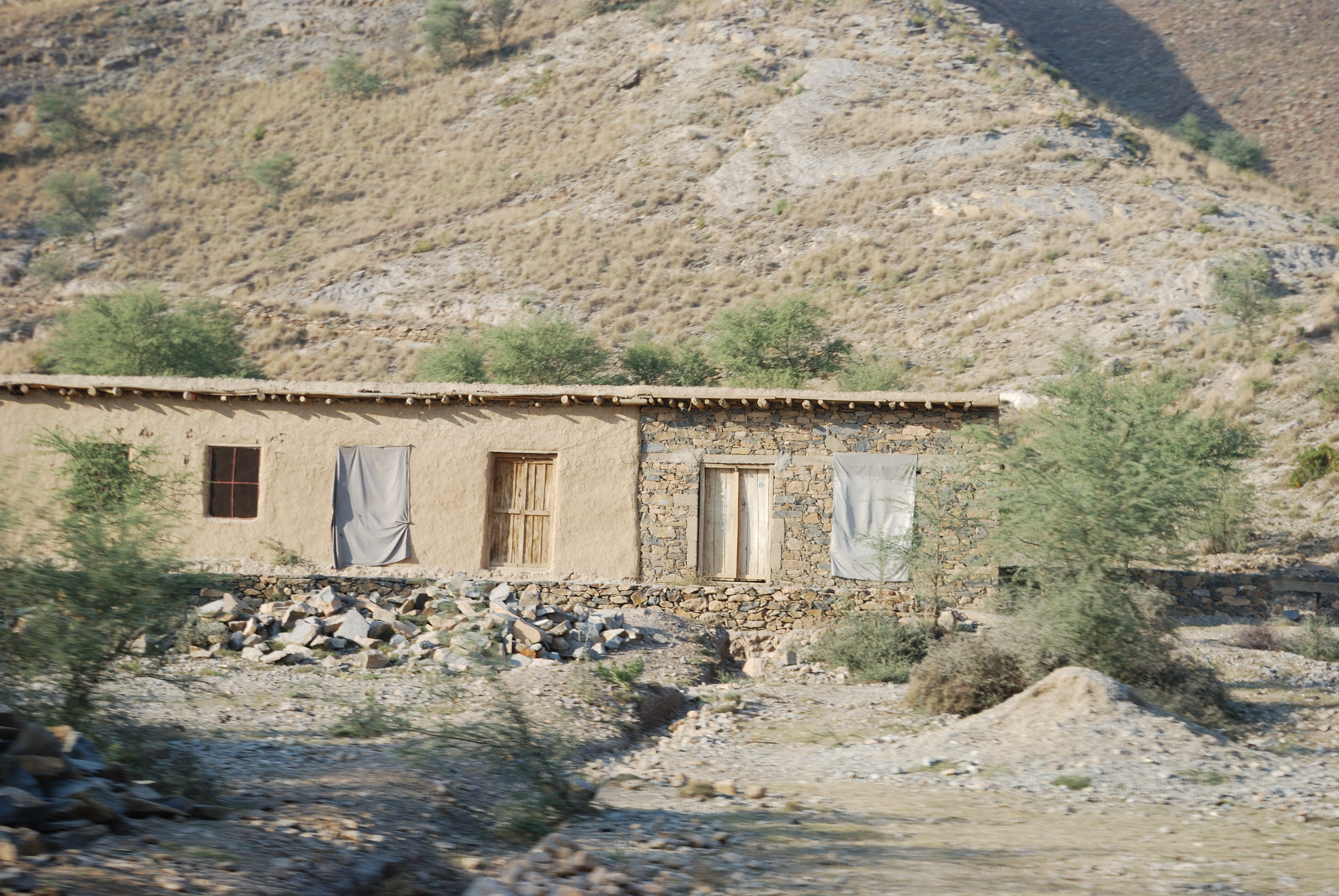 Stone boundary walls of a traditional family compound in the village